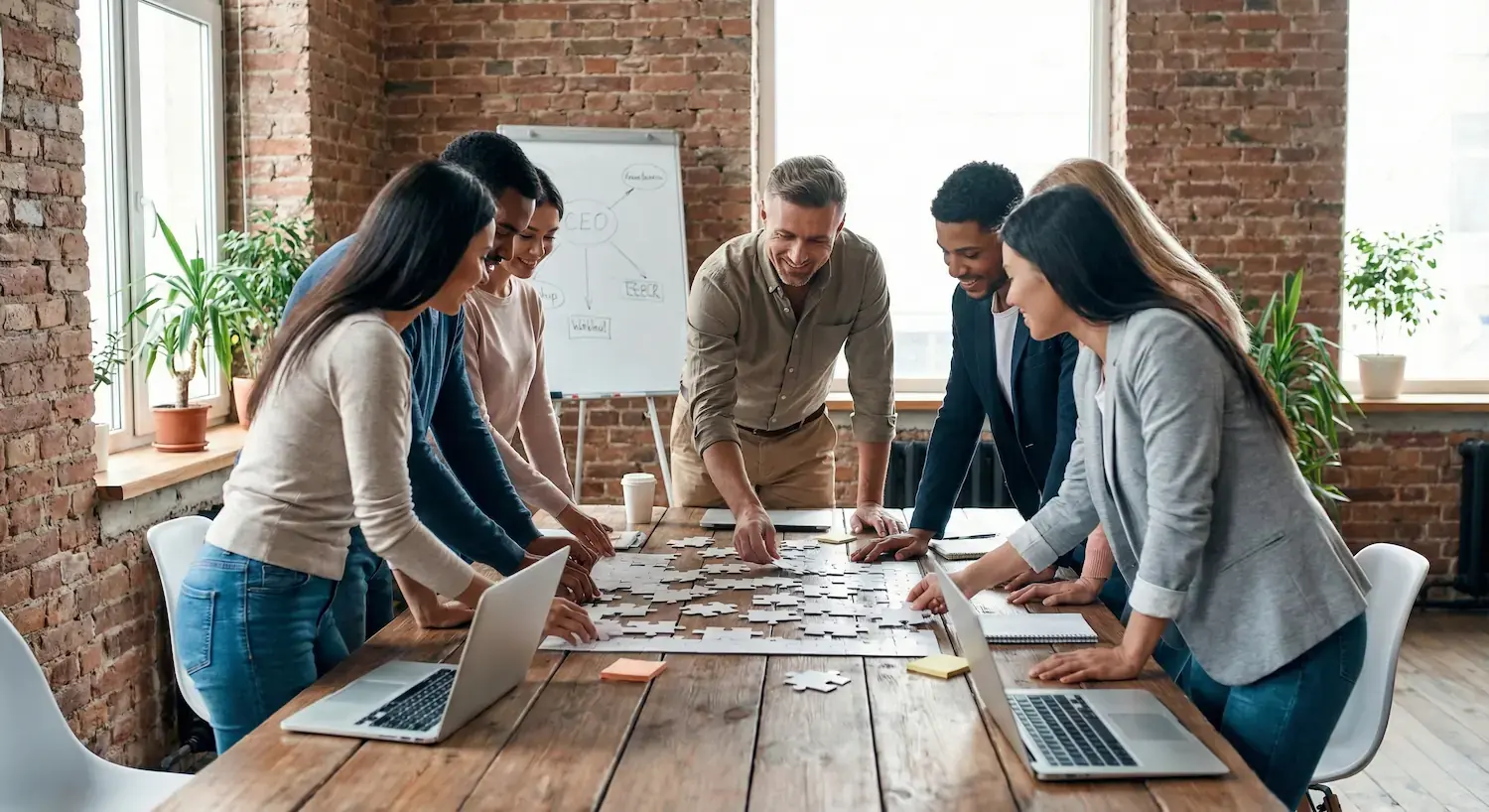 Executives surrounding a conference room table in a modern tech startup boardroom featuring glass walls, contemporary lighting, and a sleek wooden conference table